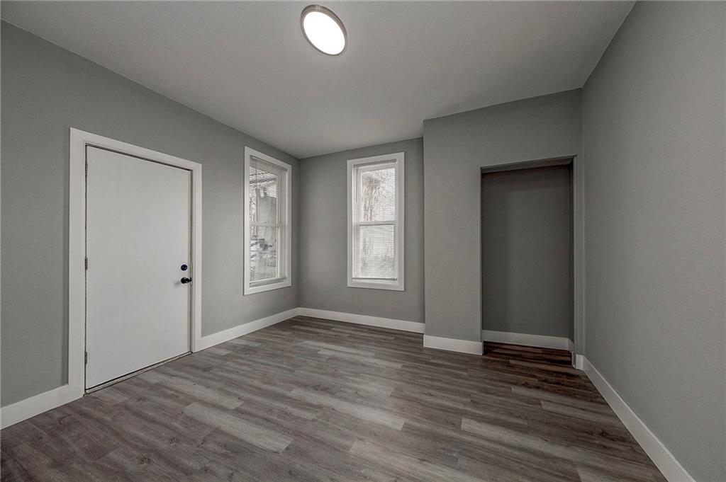 212 Ridge Avenue New Kensington, PA 15068 - Photo 14 of 32 a view of an empty room with wooden floor and a window