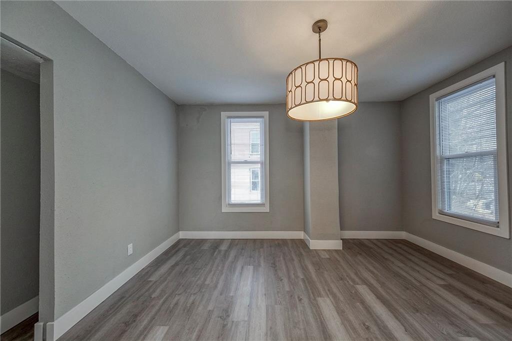 212 Ridge Avenue New Kensington, PA 15068 - Photo 16 of 32 an empty room with a window and wooden floor