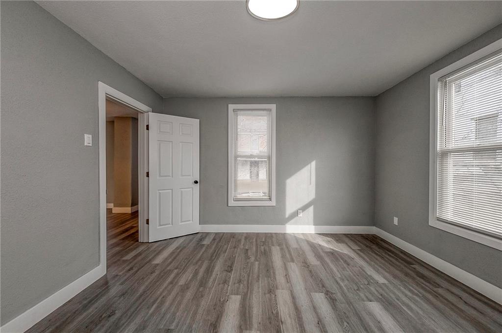 212 Ridge Avenue New Kensington, PA 15068 - Photo 19 of 32 an empty room with wooden floor and windows