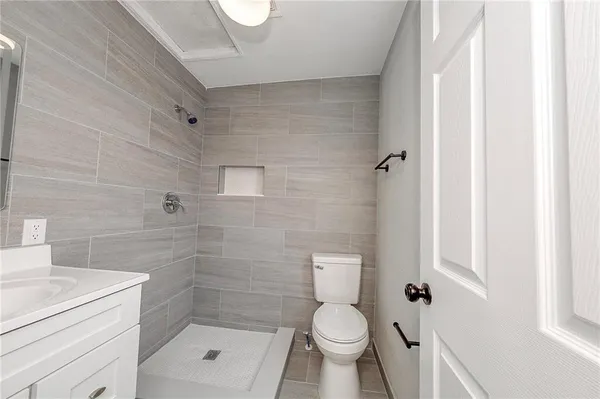 a bathroom with a toilet and a shower