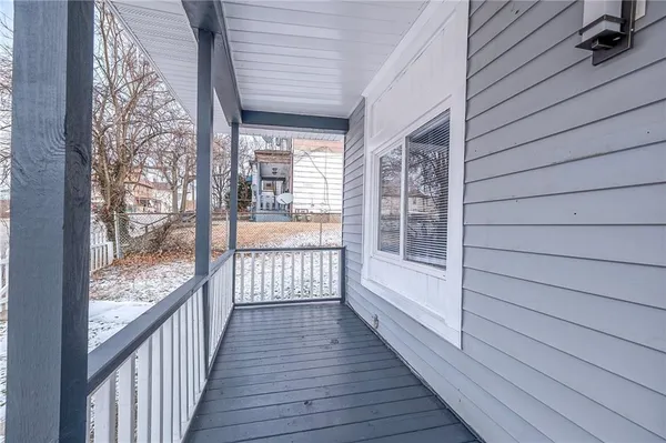 a view of a balcony with wooden floor and fence