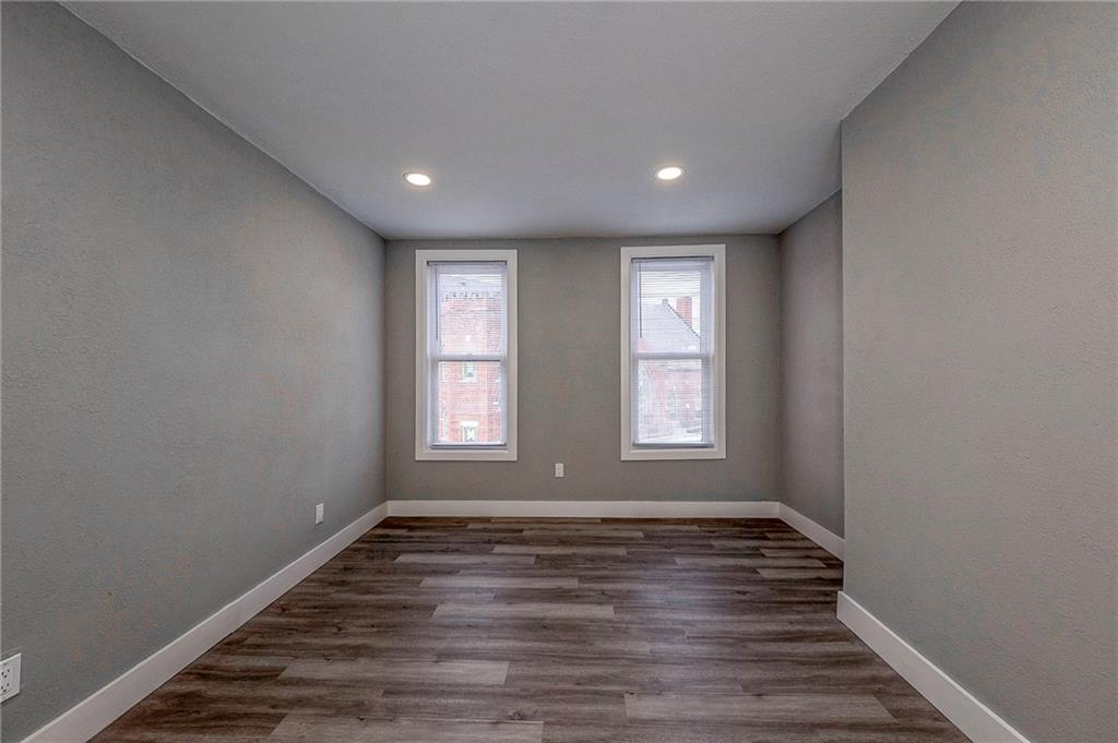 212 Ridge Avenue New Kensington, PA 15068 - Photo 23 of 32 a view of empty room with wooden floor and fan