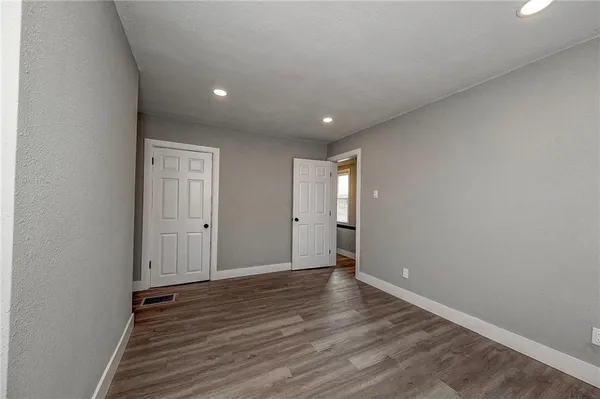 a view of an empty room and wooden floor