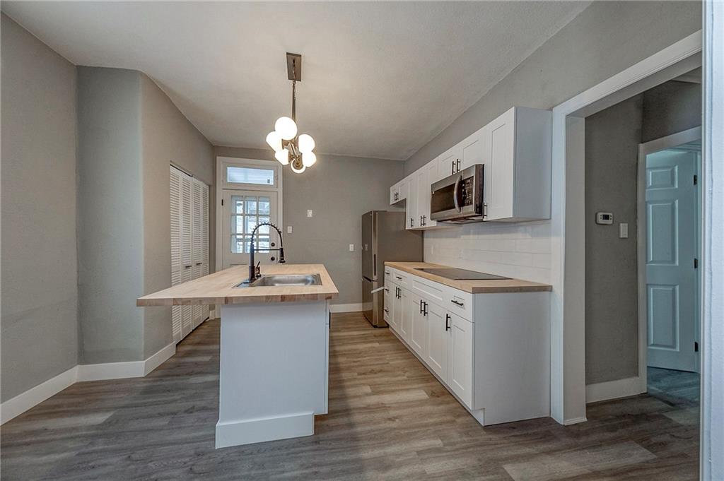 212 Ridge Avenue New Kensington, PA 15068 - Photo 7 of 32 a kitchen with stainless steel appliances granite countertop a sink stove and refrigerator