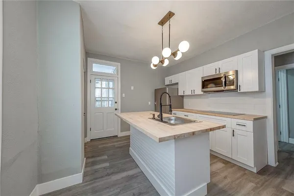 a kitchen with a sink and a mirror