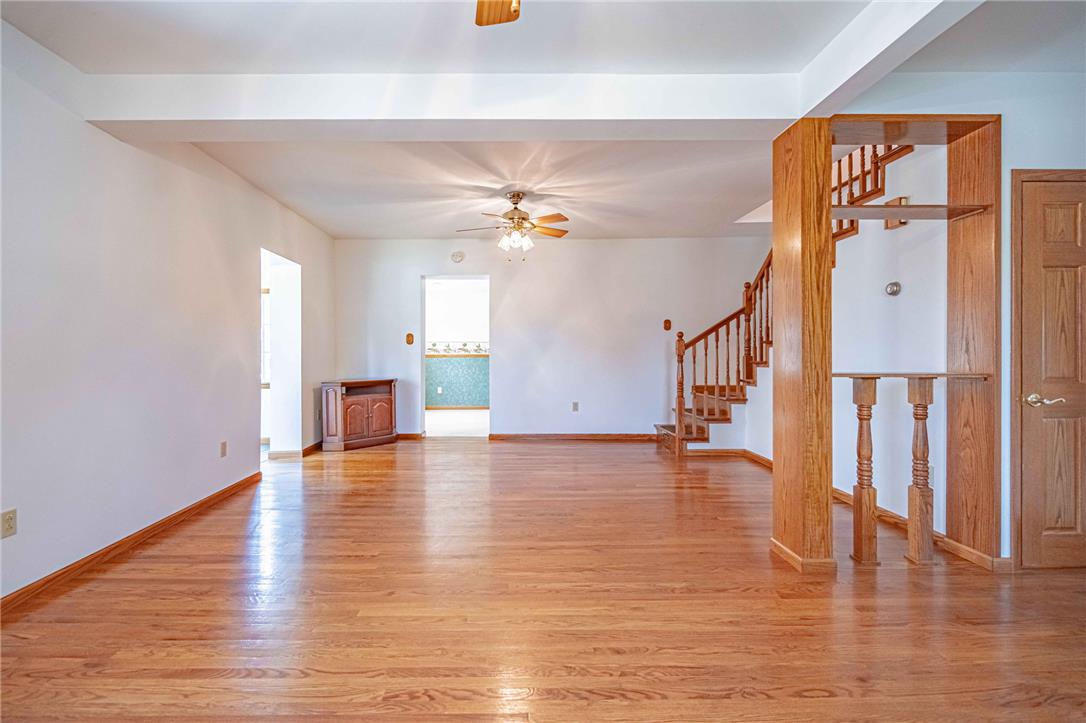 4165 East Texas Road Allentown, PA 18103 - Photo 12 of 56 Hardwood flooring extends throughout this generous living space, leading to a gracefully ascending staircase.