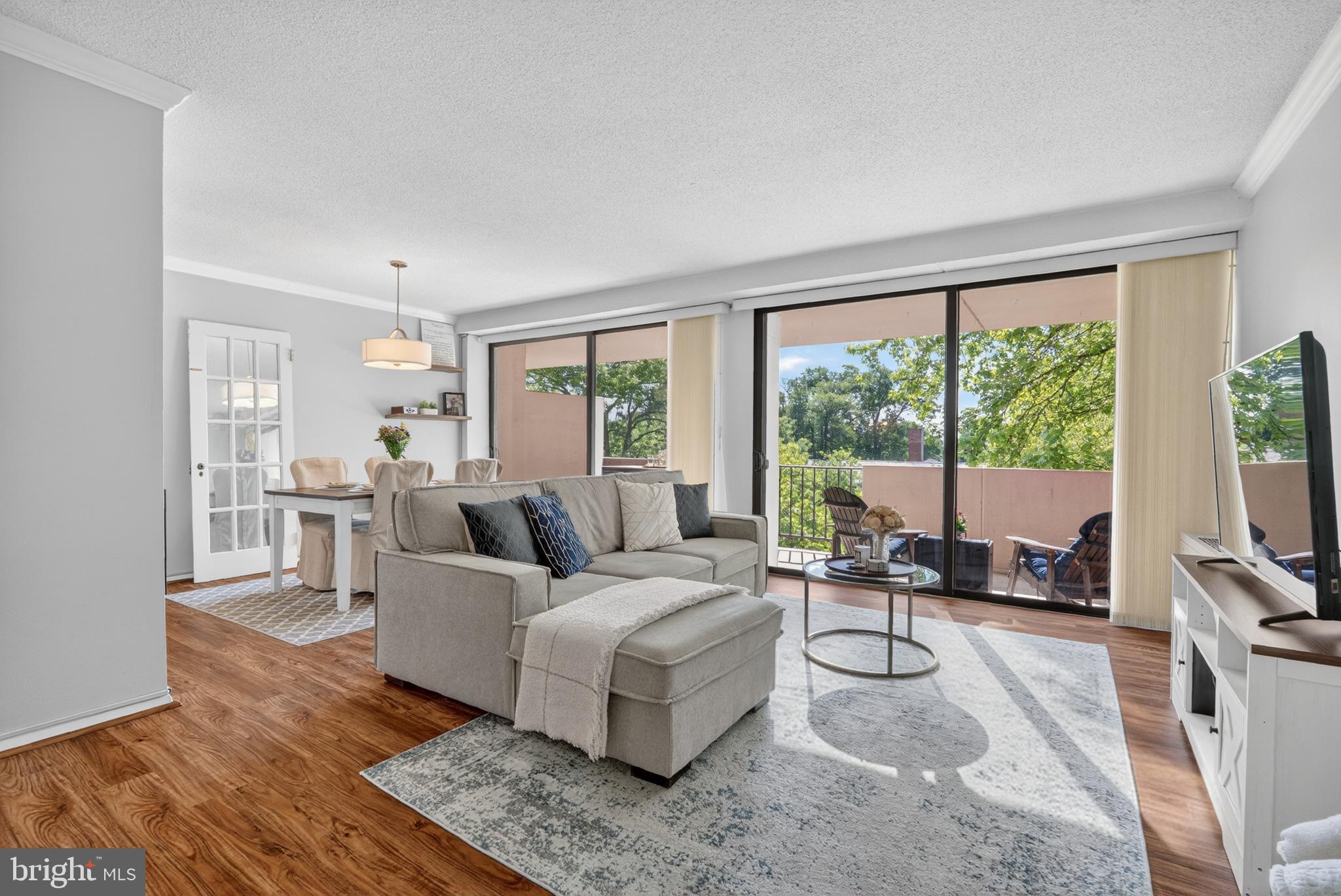 a living room with furniture and large windows