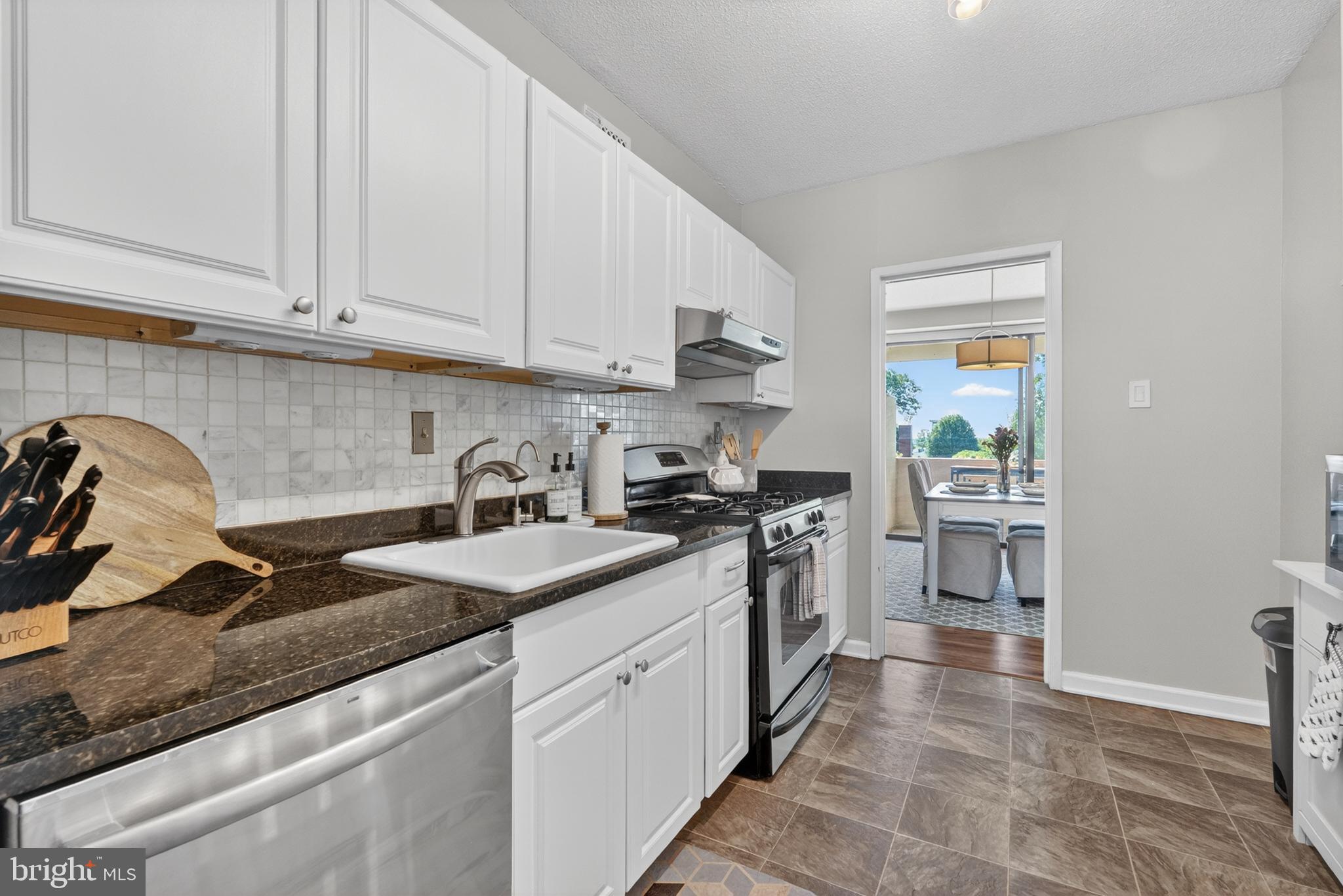 4141 North Henderson Road, Unit 302 Arlington, VA 22203 - Photo 12 of 40 a kitchen with granite countertop a sink stainless steel appliances and cabinets