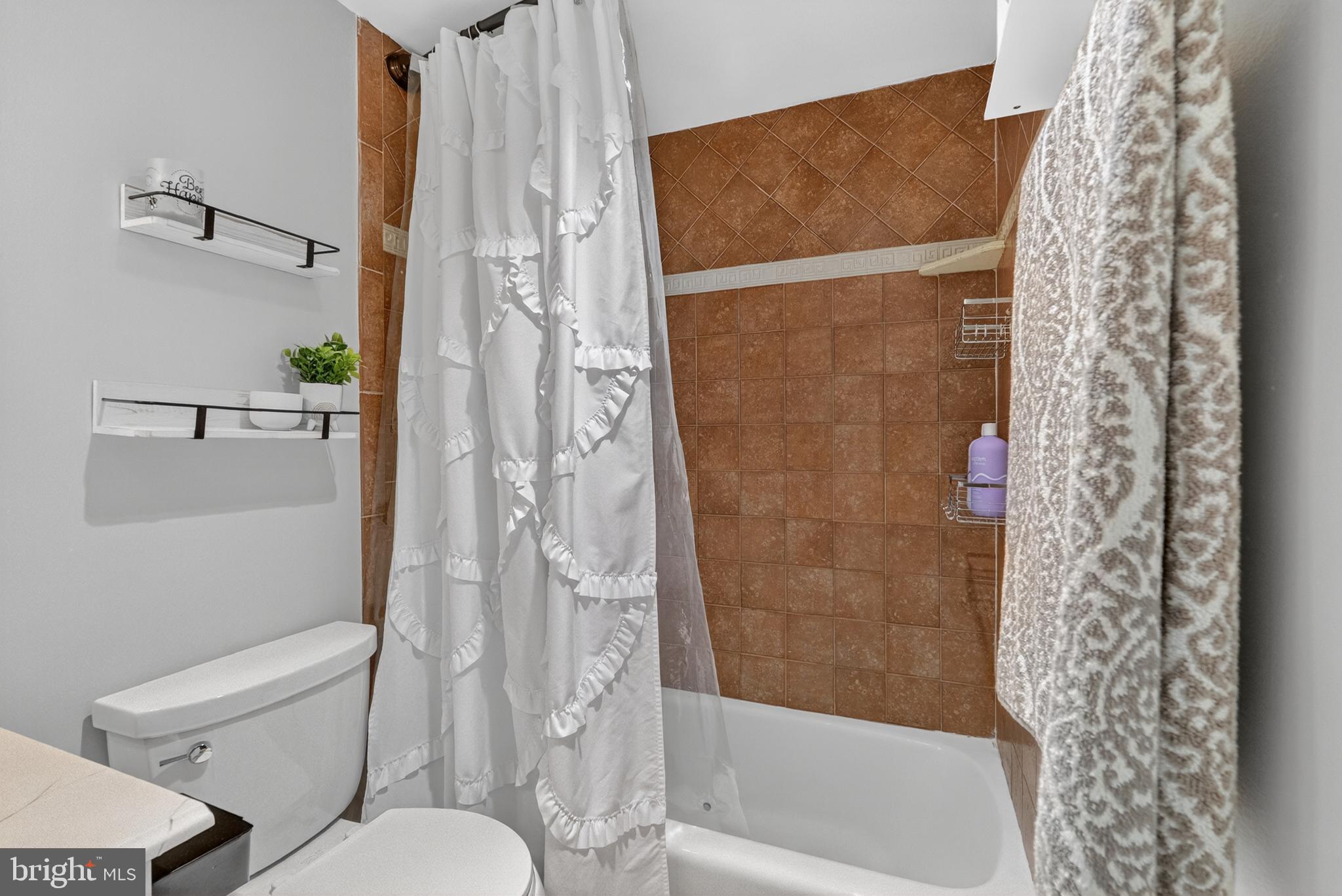 4141 North Henderson Road, Unit 302 Arlington, VA 22203 - Photo 18 of 40 a bathroom with a toilet and shower