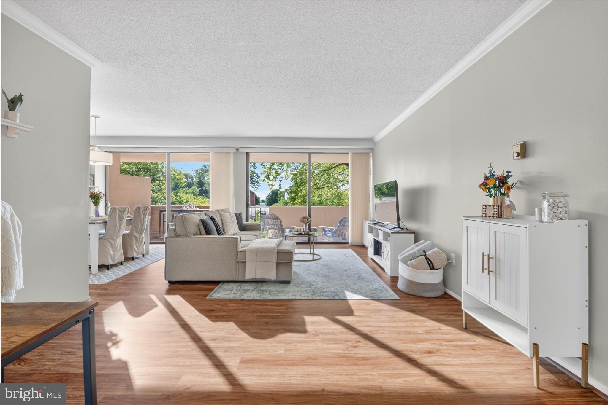 4141 North Henderson Road, Unit 302 Arlington, VA 22203 - Photo 3 of 40 a living room with furniture and large windows