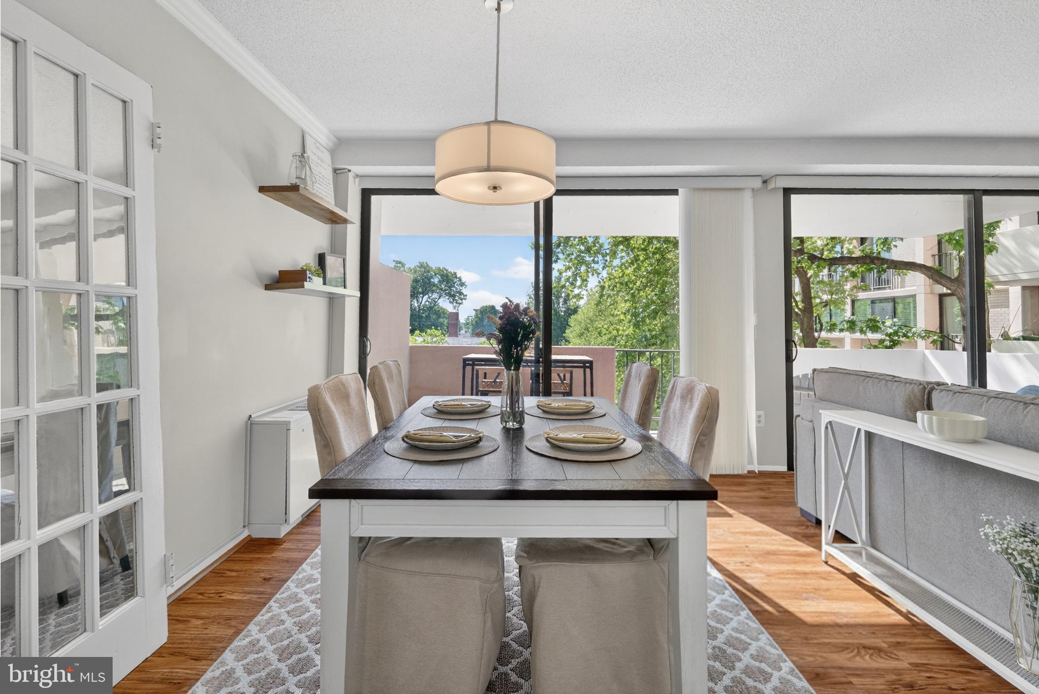 4141 North Henderson Road, Unit 302 Arlington, VA 22203 - Photo 7 of 40 a dining room with wooden floor a chandelier a wooden table and chairs