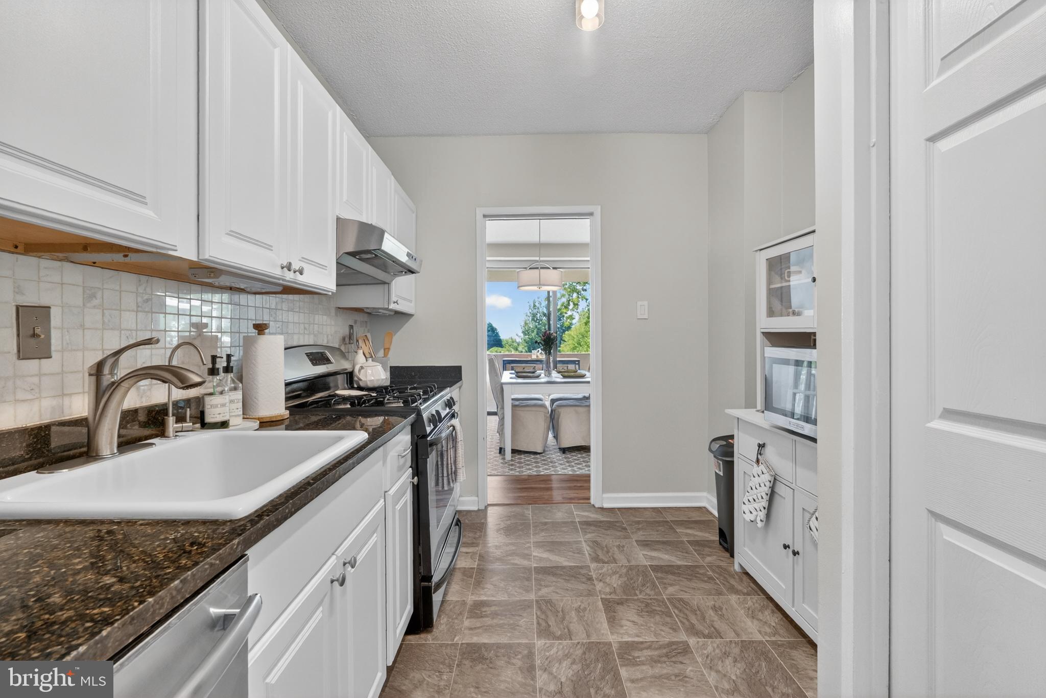 4141 North Henderson Road, Unit 302 Arlington, VA 22203 - Photo 10 of 40 a kitchen with a sink stove and refrigerator