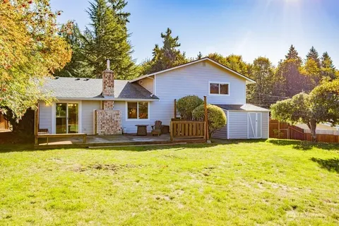 a view of a house with swimming pool and a yard