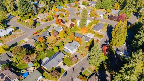 an aerial view of a house with a yard and garden