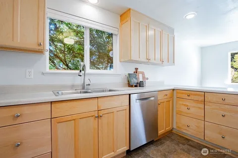 a kitchen with sink cabinets and window
