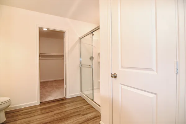 a view of a hallway with wooden floor