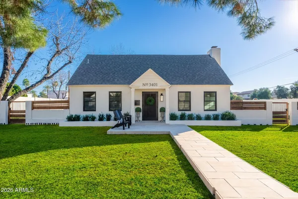 a front view of a house with swimming pool having outdoor seating