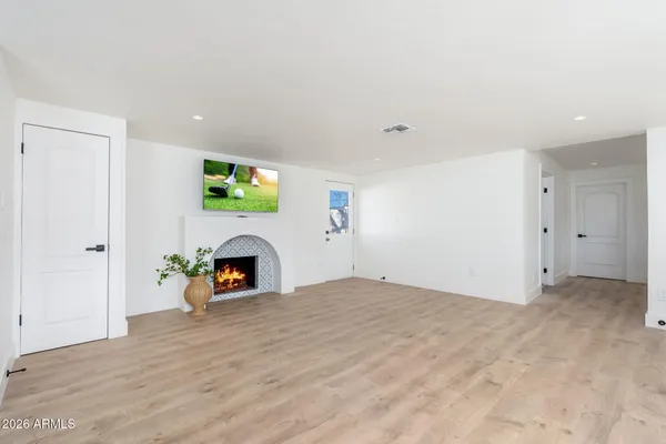 a view of empty room with a fireplace