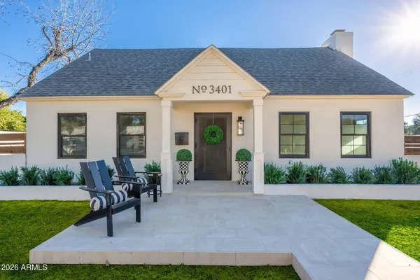 a front view of house with yard and outdoor seating