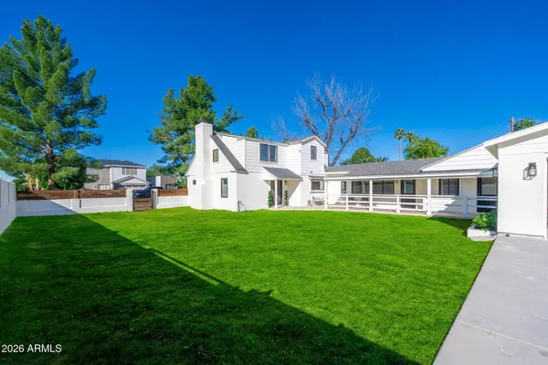 a view of backyard with seating area and green space