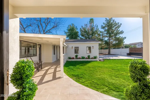 a front view of a house with yard patio and green space