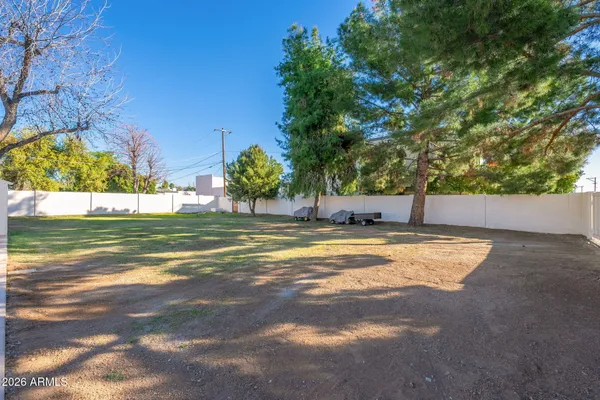 a view of a patio with table and chairs and potted plants