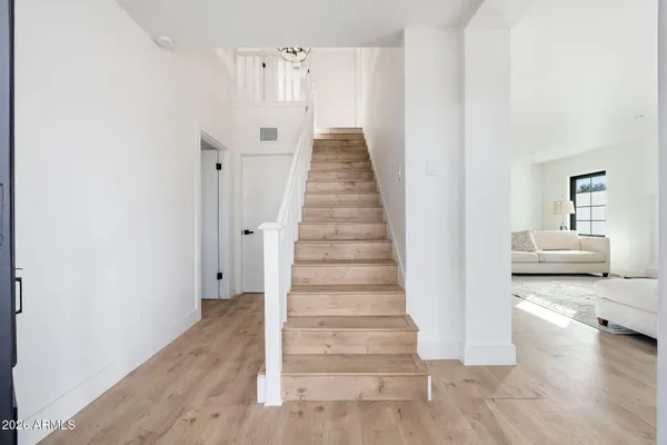 a view of a hallway with wooden floor and entryway