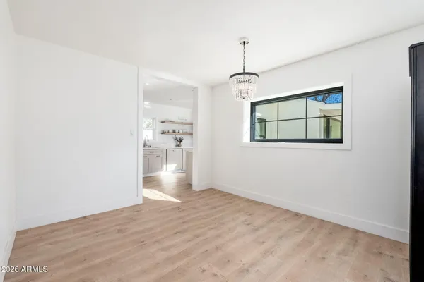 a view of an empty room with a kitchen