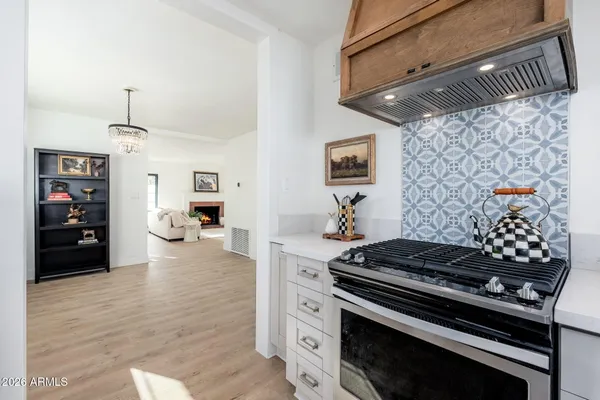 a kitchen with stove and cabinets
