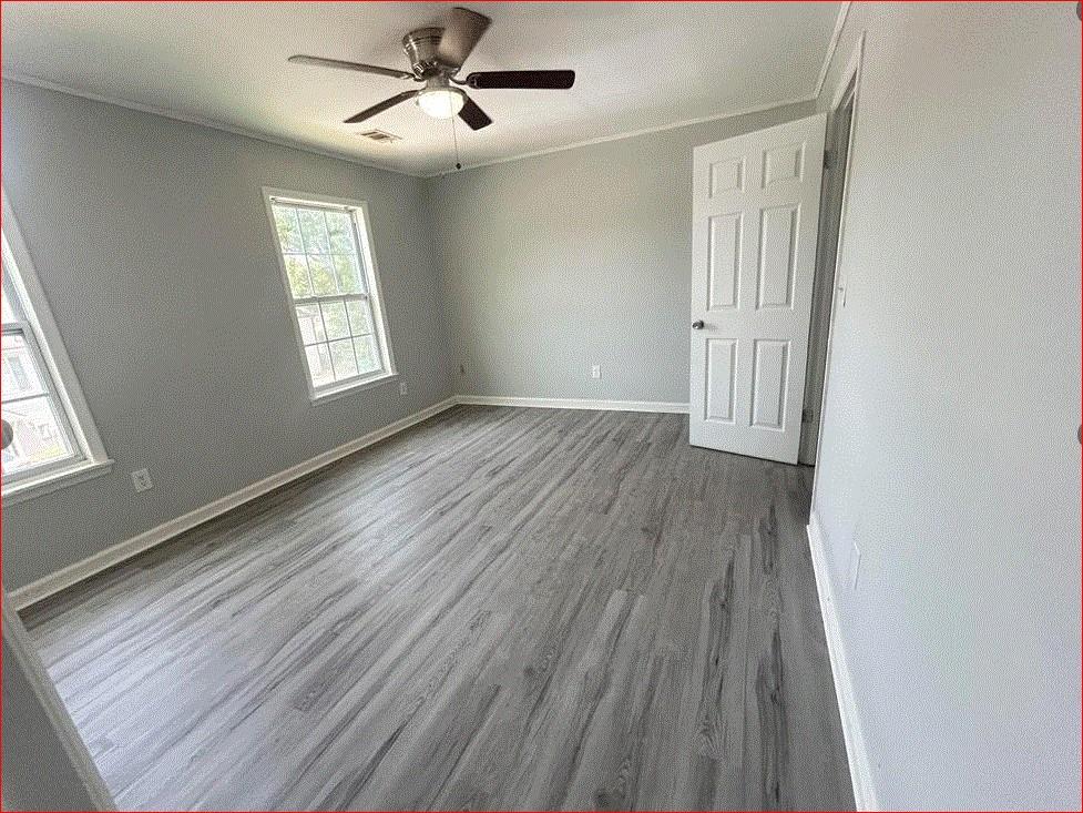 1021 Thorn Woode Lane Stone Mountain, GA 30083 - Photo 4 of 6 a view of an empty room with wooden floor and a window