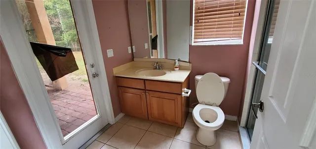 a bathroom with a toilet a sink and a mirror