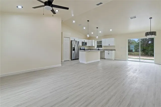 a view of a kitchen with a sink and microwave
