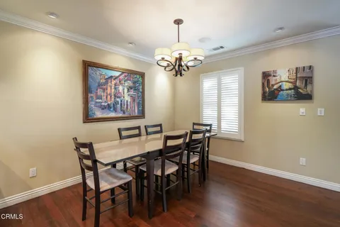 a view of a dining room with furniture wooden floor and a chandelier