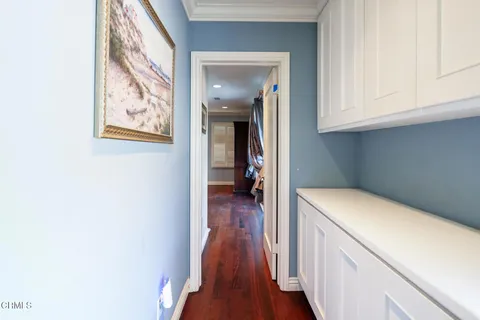 a view of hallway with wooden floor
