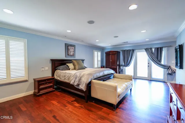 a spacious bedroom with a bed and a window