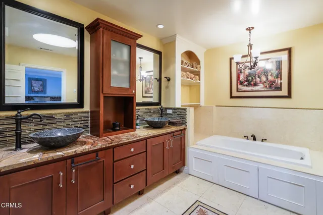 a spacious bathroom with a double vanity sink and a mirror