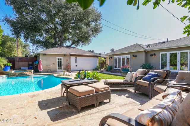 a backyard of a house with yard table and chairs
