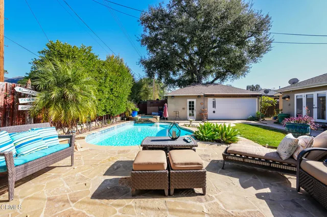 a house view with a sitting space garden and patio
