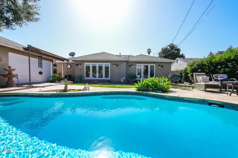 a swimming pool view with a outdoor seating