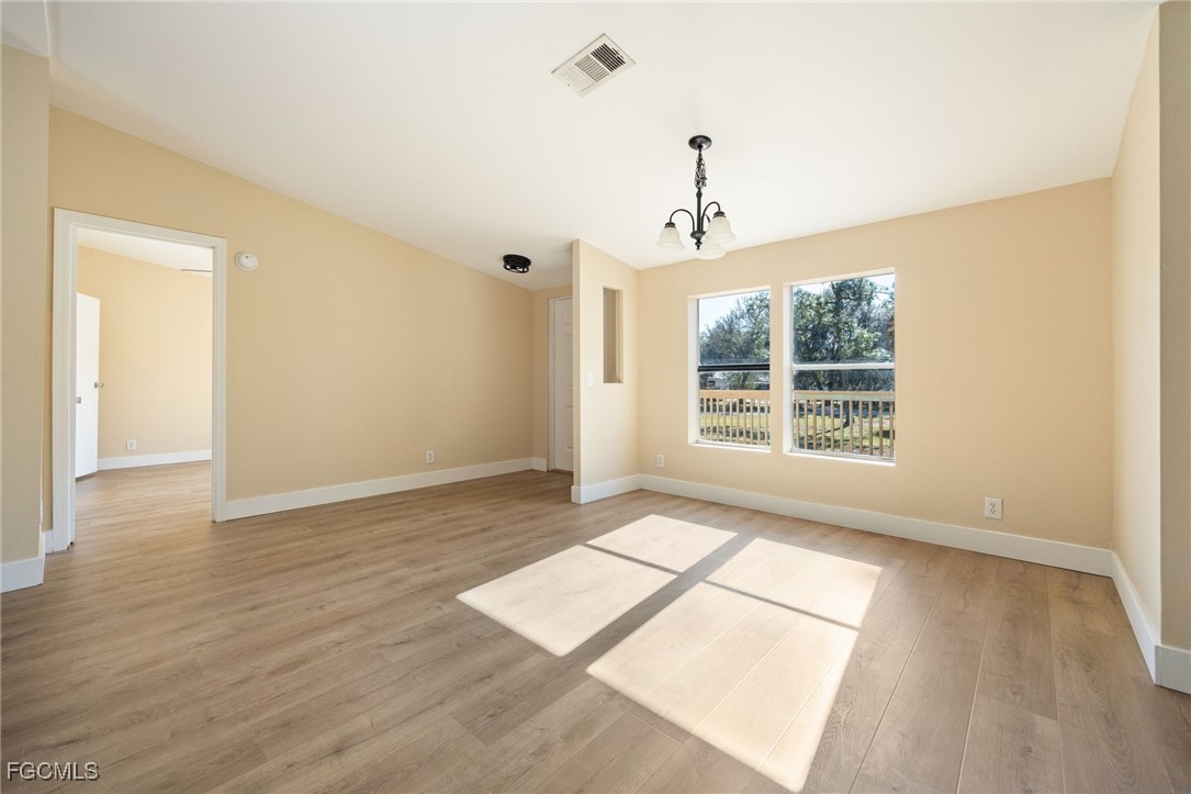 250 Trader Road LaBelle, FL 33935 - Photo 11 of 42 an empty room with wooden floor and windows