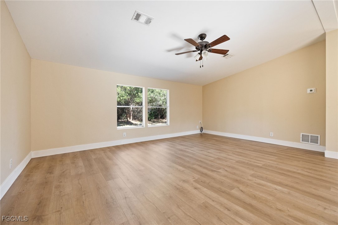 250 Trader Road LaBelle, FL 33935 - Photo 15 of 42 a view of empty room with wooden floor and fan