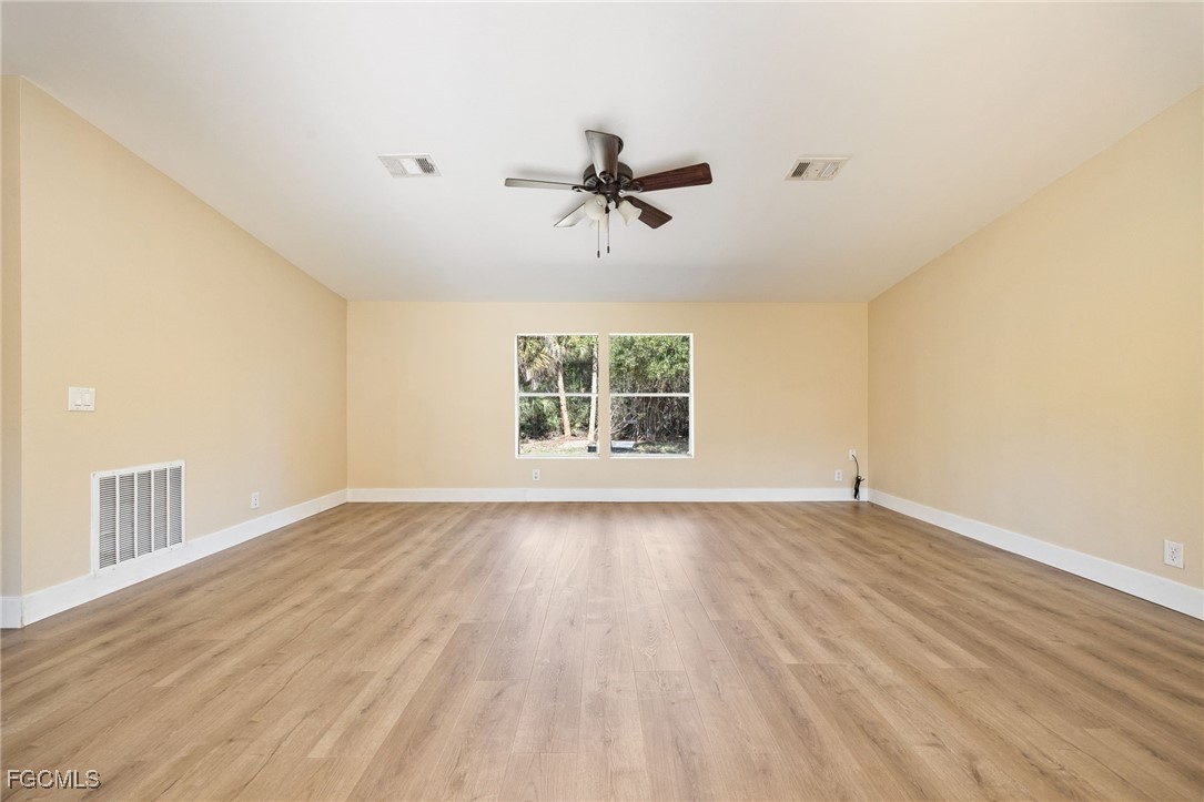 250 Trader Road LaBelle, FL 33935 - Photo 16 of 42 wooden floor in an empty room with a window