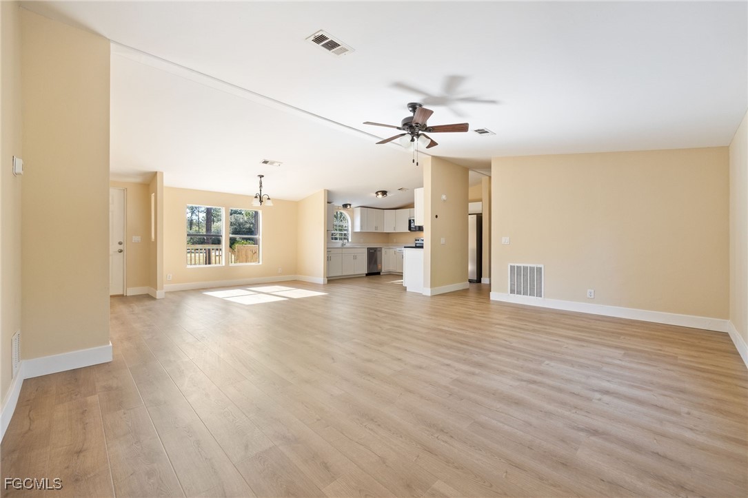 250 Trader Road LaBelle, FL 33935 - Photo 18 of 42 a view of empty room with wooden floor and fan