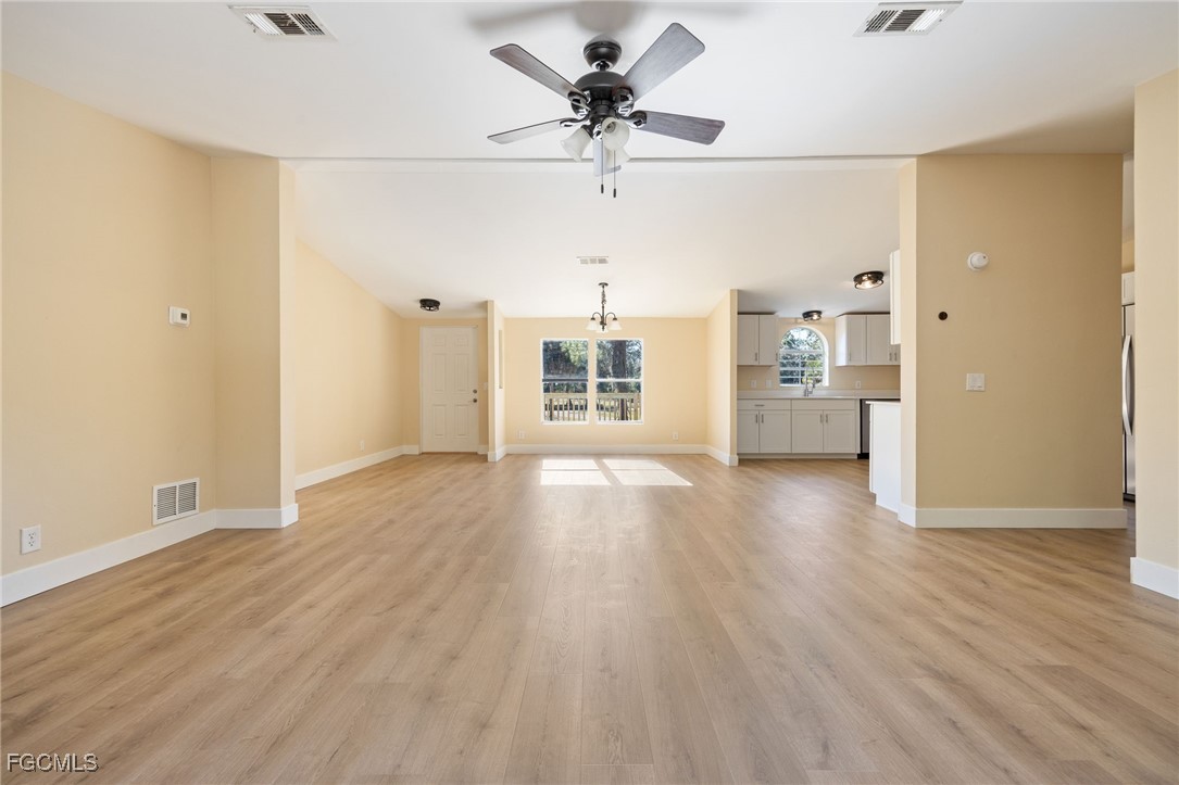 250 Trader Road LaBelle, FL 33935 - Photo 19 of 42 wooden floor in an empty room with a window