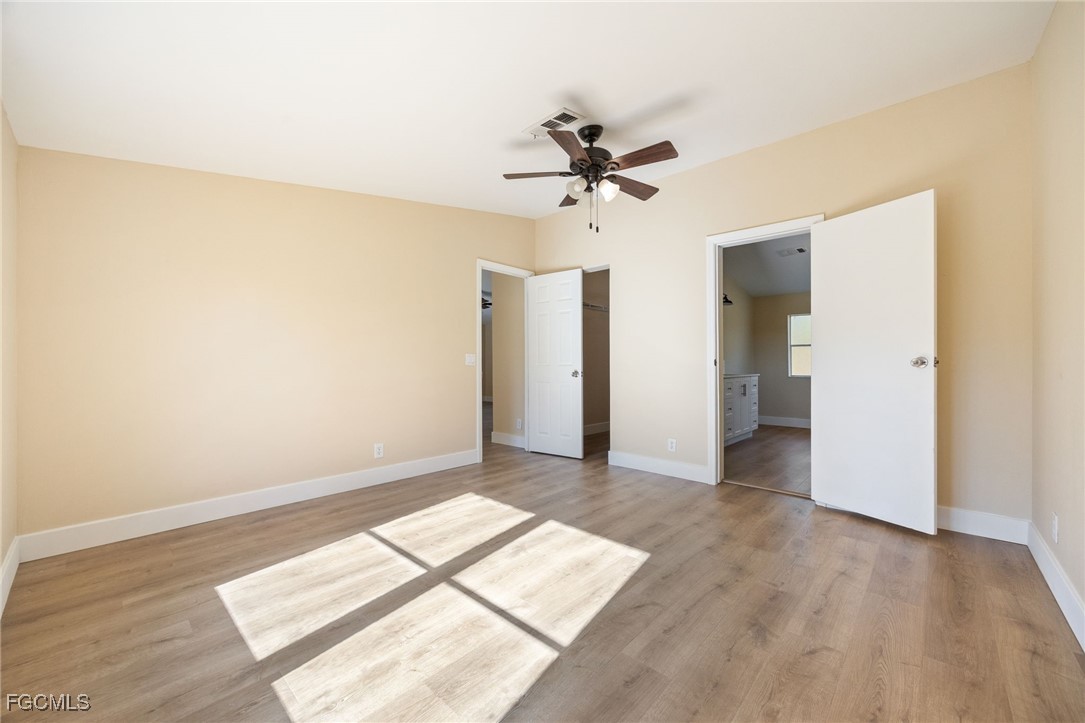 250 Trader Road LaBelle, FL 33935 - Photo 22 of 42 a view of a big room with wooden floor and windows in a room