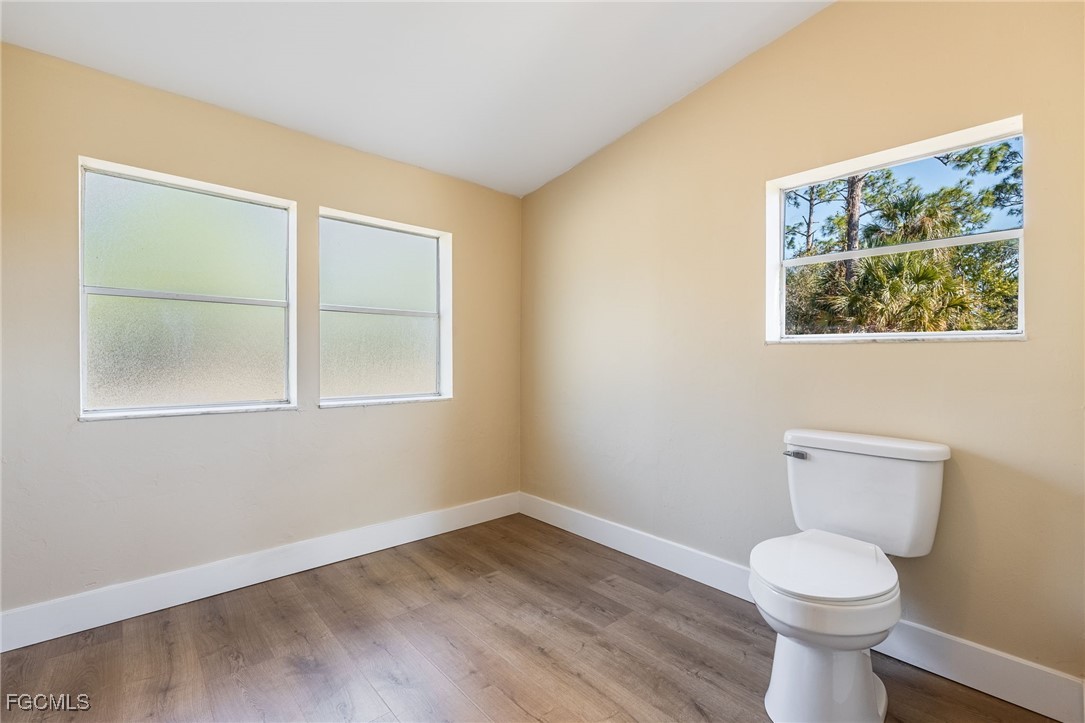 250 Trader Road LaBelle, FL 33935 - Photo 26 of 42 a view of a room with wooden floor and a toilet