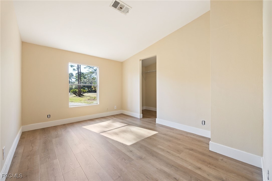 250 Trader Road LaBelle, FL 33935 - Photo 27 of 42 an empty room with wooden floor and windows