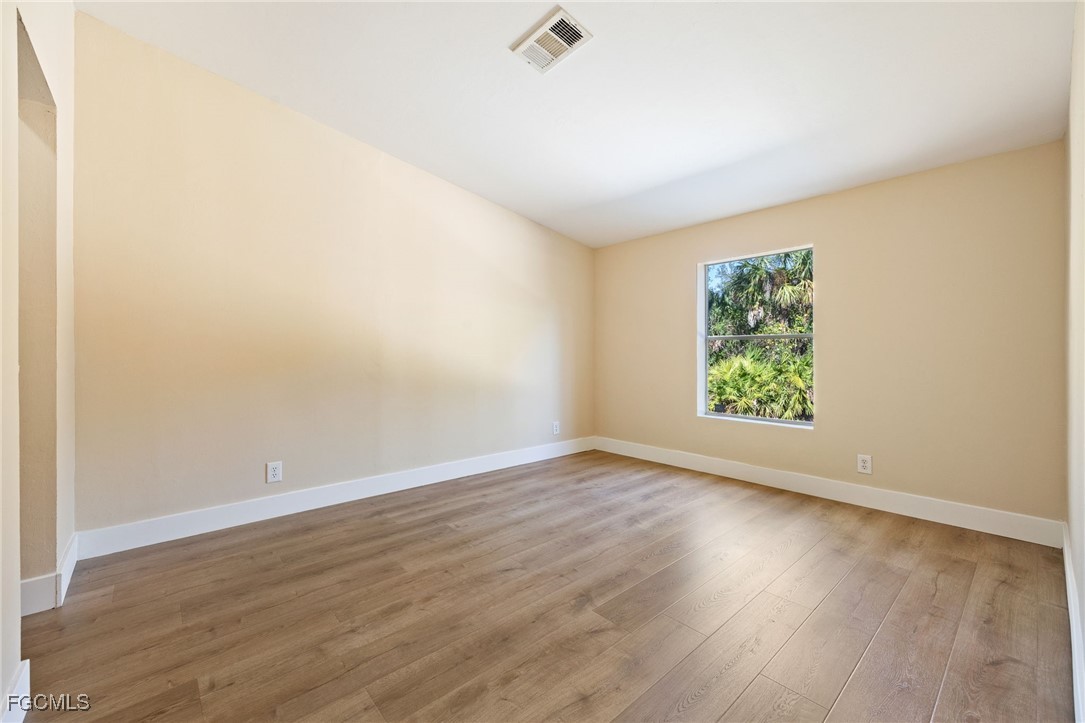 250 Trader Road LaBelle, FL 33935 - Photo 30 of 42 an empty room with wooden floor and windows