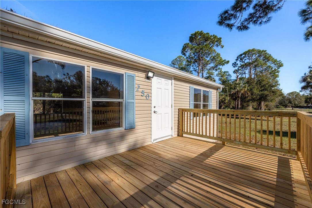 250 Trader Road LaBelle, FL 33935 - Photo 5 of 42 a view of a house with wooden deck