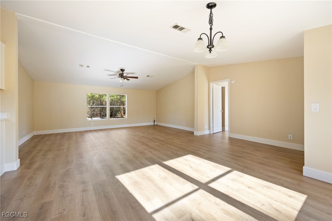 250 Trader Road LaBelle, FL 33935 - Photo 9 of 42 a view of an empty room with wooden floor and a window
